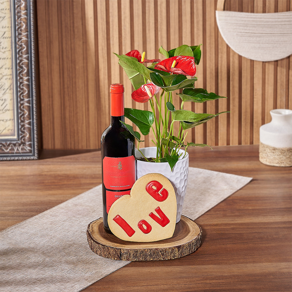 This Valentine's Day, show someone special they're on your mind with a bottle of wine, a potted Anthurium plant, a heart-shaped cookie that says ‘love’, and a live-edge serving board, Chicago delivery 